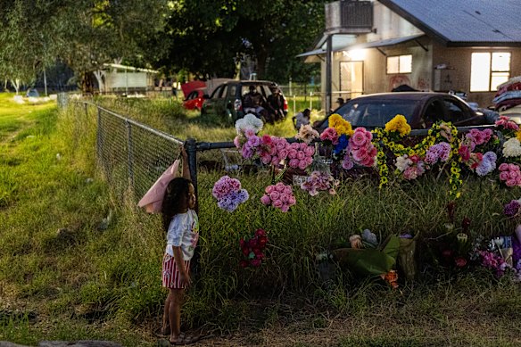 Hendricks Alosio joins community members at a flower tribute for Kumanjayi Little Baby.