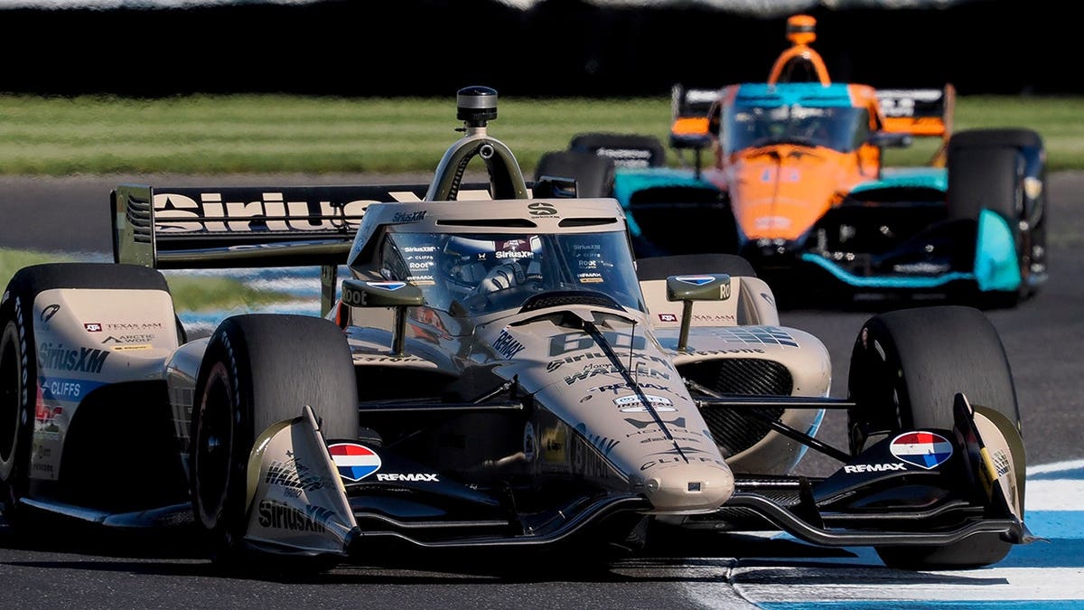 Felix Rosenqvist driving car number 60 through a turn at Indianapolis Motor Speedway.
