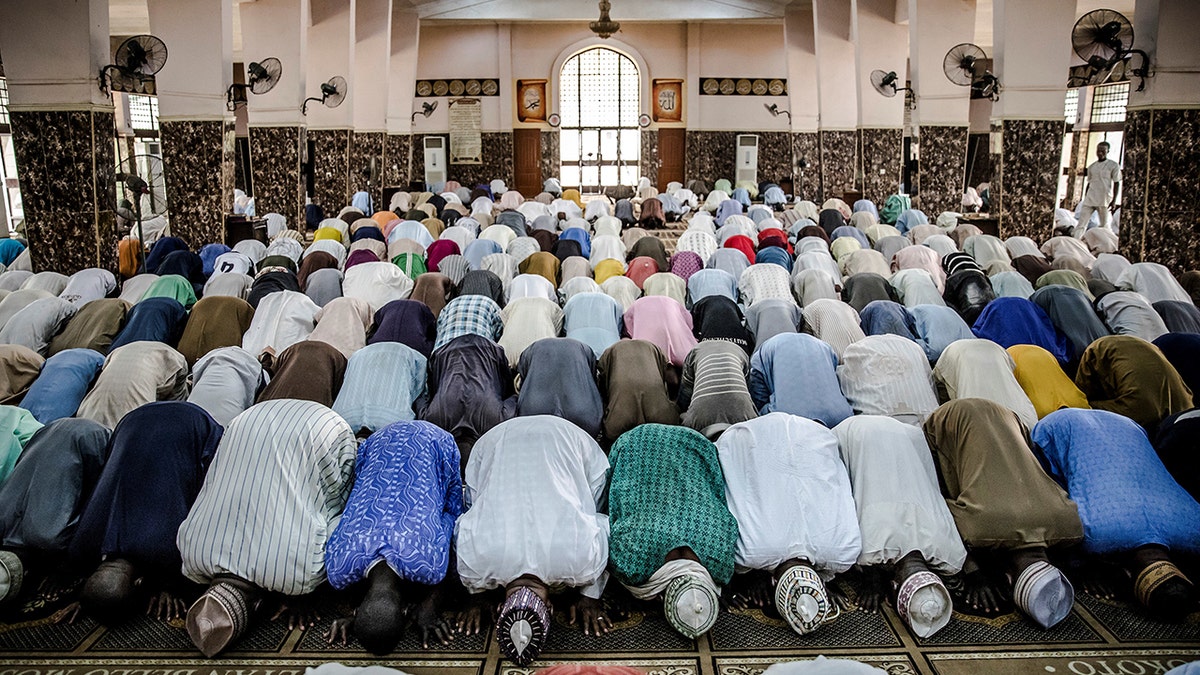 Fulani men praying