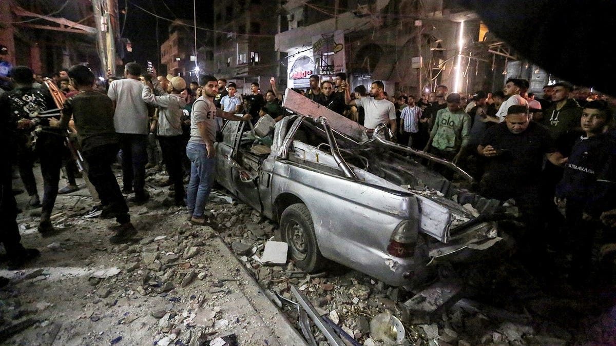 Emergency teams responding to damage at a residential building in Gaza City after airstrikes