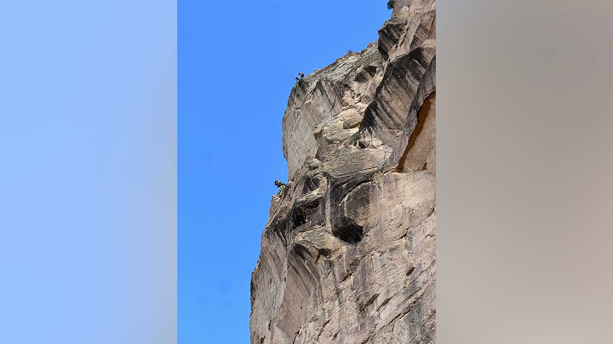 Rescue crews conduct technical rope operations along steep cliffs at the Grand Canyon during missing person search