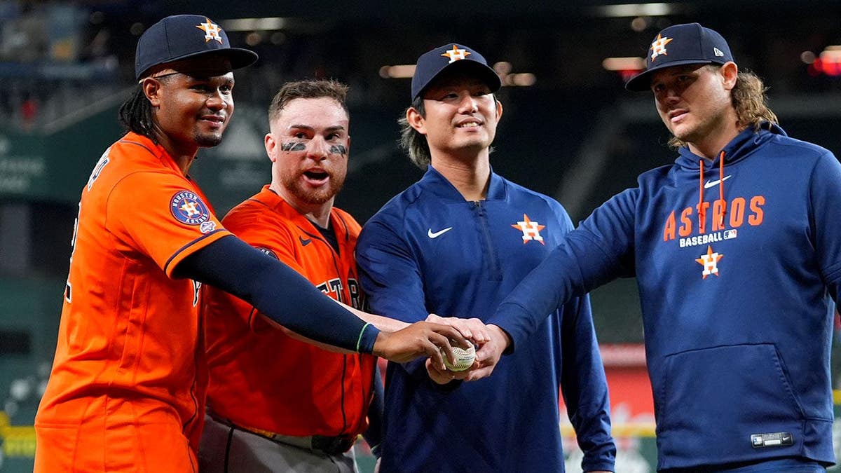 Houston Astros pitchers Alimber Santa, Tatsuya Imai, and Steven Okert posing with catcher Christian Vázquez
