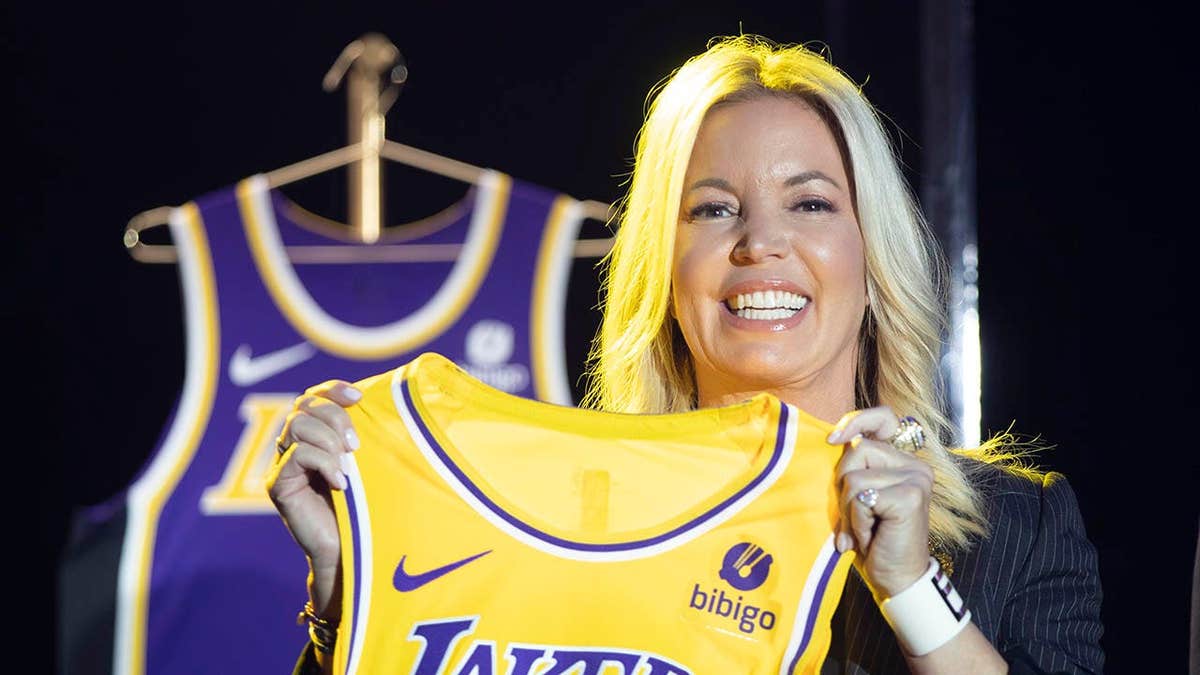 Jeanie Buss holding a new Los Angeles Lakers jersey at an event