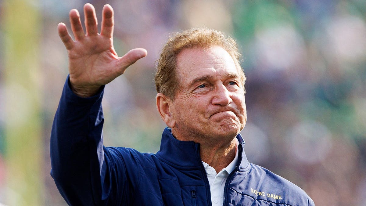 Former Notre Dame quarterback Joe Theismann waving to crowd at Notre Dame Stadium
