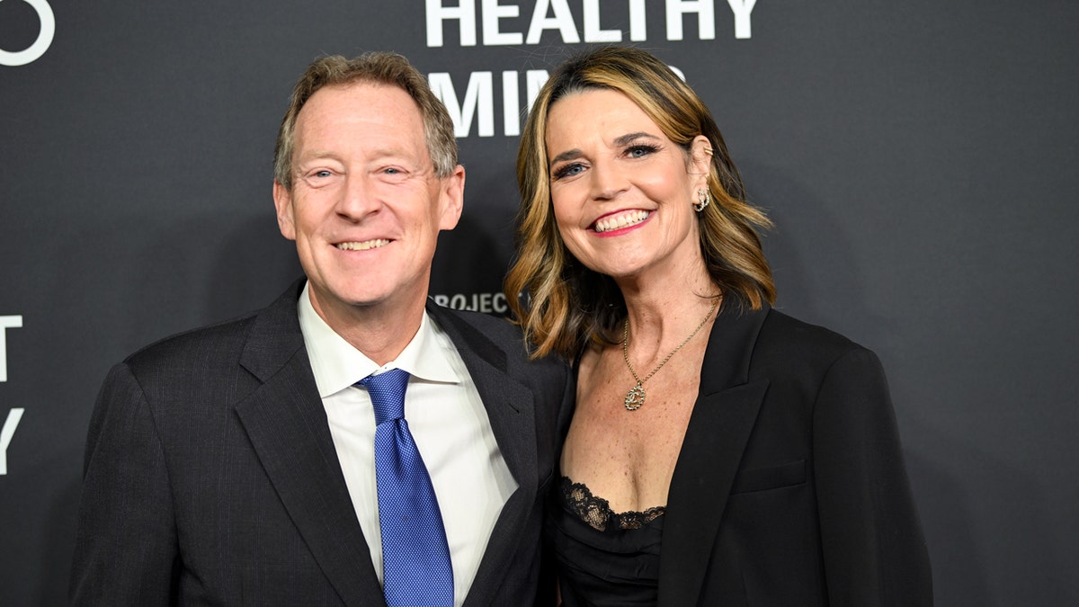 Michael Feldman and Savannah Guthrie standing together at an event