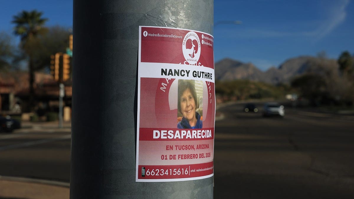A sign reading Nancy Guthrie Desparecida placed on a pole in Tucson, Arizona.