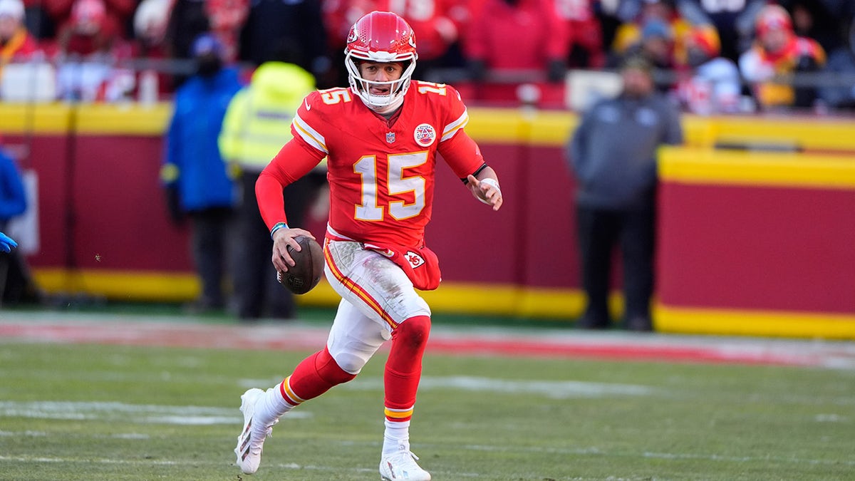 Kansas City Chiefs quarterback Patrick Mahomes scrambling during a football game.