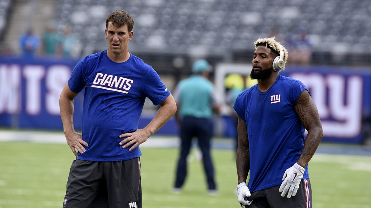 New York Giants quarterback Eli Manning and wide receiver Odell Beckham Jr. warming up on field