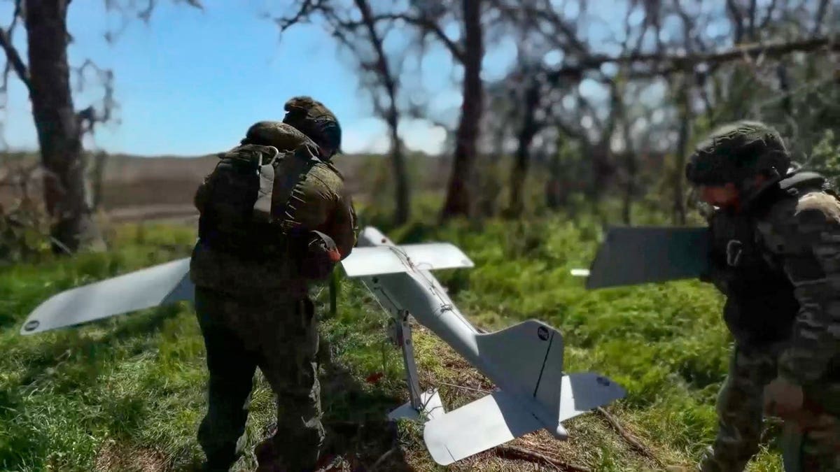 Russian servicemen prepare to launch an interceptor drone for an action in an undisclosed location in Ukraine