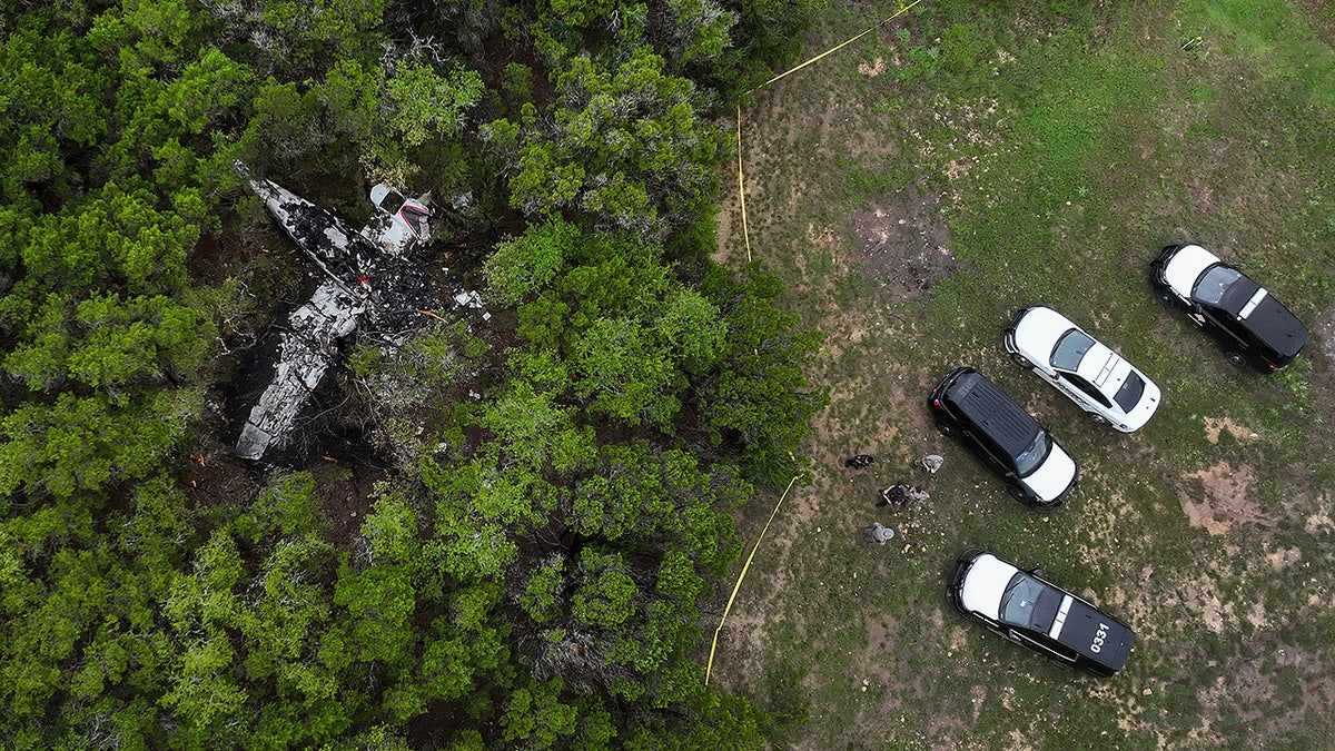 A crashed Cessna airplane is seen in a wooded area on Round Rock Road in Wimberley, Texas