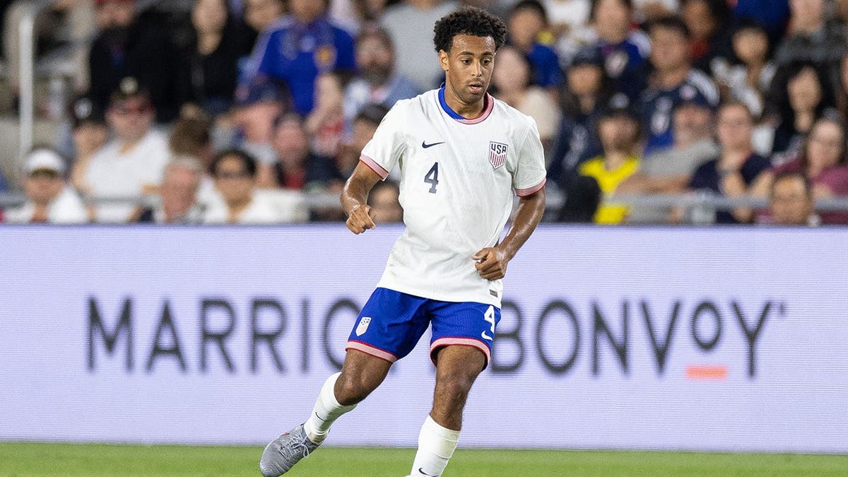 Tyler Adams advancing the ball during a soccer game at Lower.com Field in Columbus, Ohio