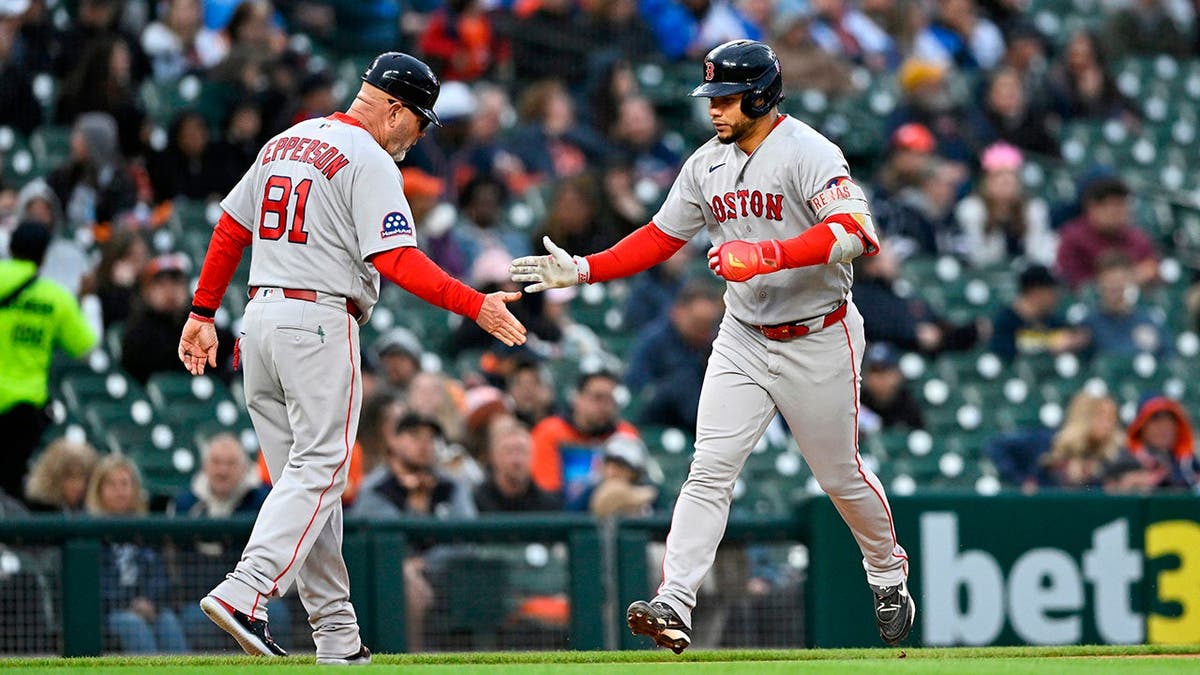 Boston Red Sox's Willson Contreras celebrating with coach Chad Epperson after hitting a homerun