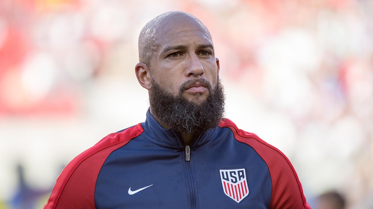 United States goalkeeper Tim Howard standing on the field before a soccer match.