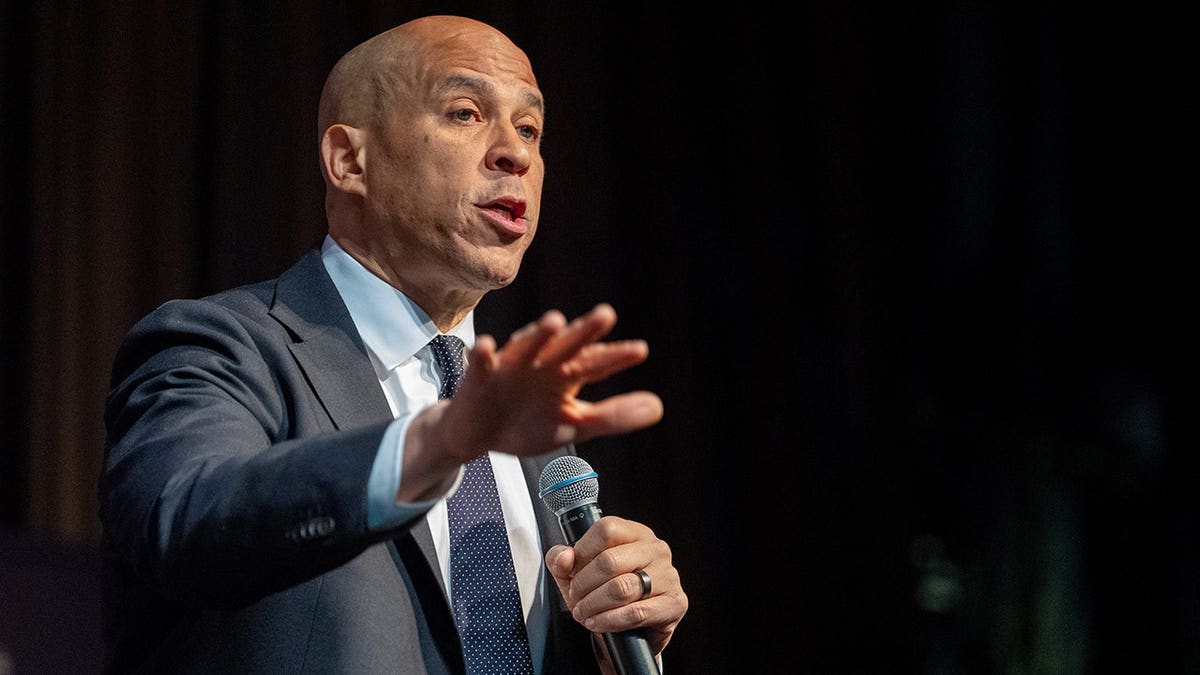 Senator Booker speaking into a microphone.