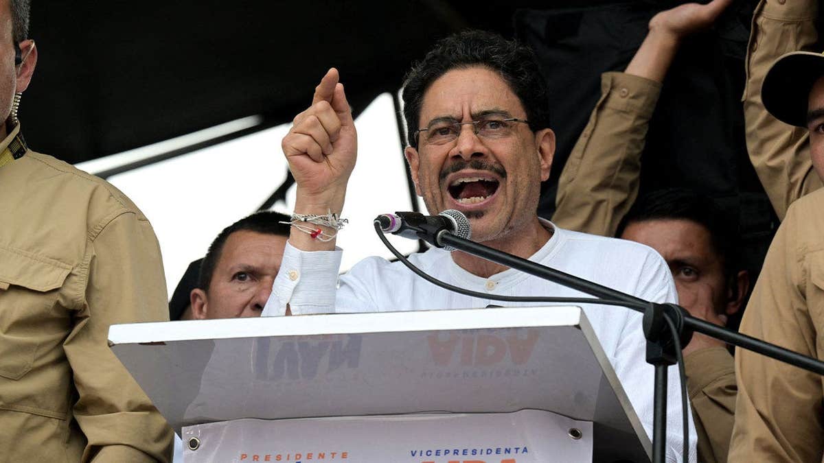 Ivan Cepeda standing at a podium speaking during a campaign rally