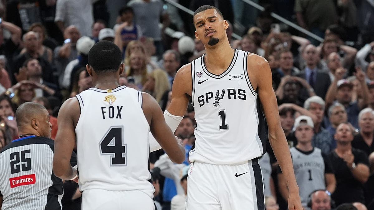 Victor Wembanyama and De'aaron Fox reacting after a foul call during the NBA Finals