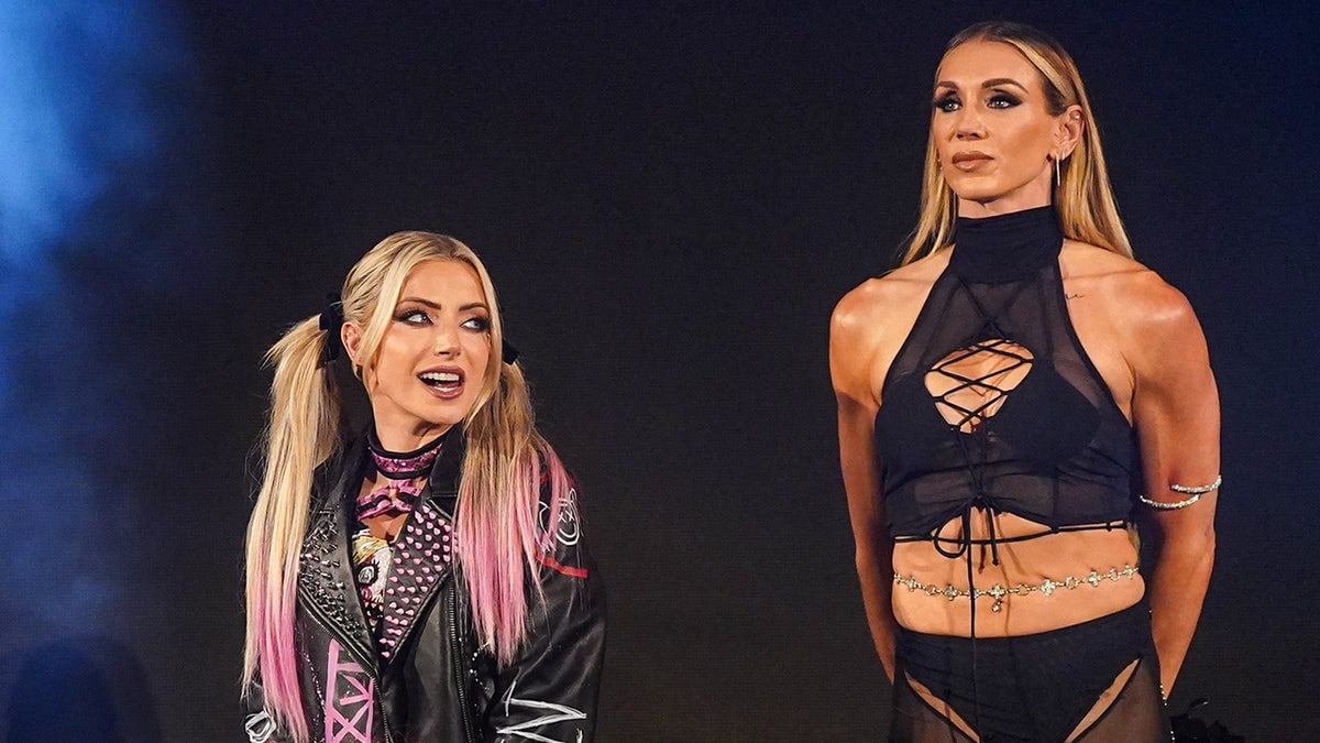 Alexa Bliss and Charlotte Flair walking to the ring during SmackDown at Rocket Mortgage Fieldhouse in Cleveland