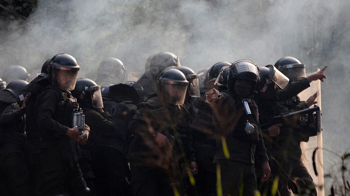 Police officers firing tear gas at community members at Humberto Suarez oil facility in Bolivia