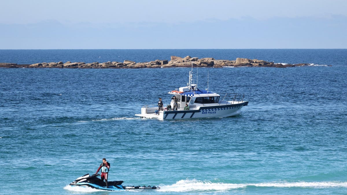 A lifeguard and a NSW Police boat patrol Coogee Beach following a shark attack in Sydney, Australia, June 13, 2026.