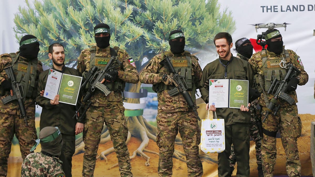 Al-Qassam Brigades members handing over Israeli hostages to International Committee of the Red Cross in Gaza