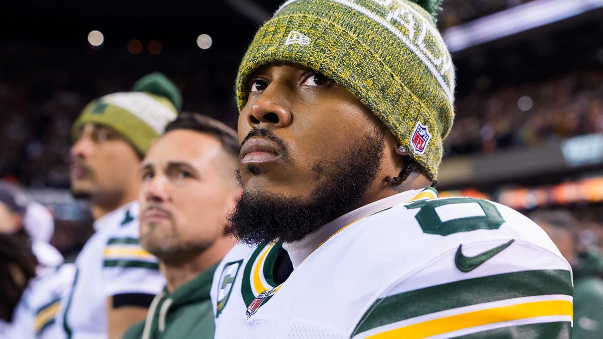 Josh Jacobs of the Green Bay Packers standing for the National Anthem at Soldier Field.