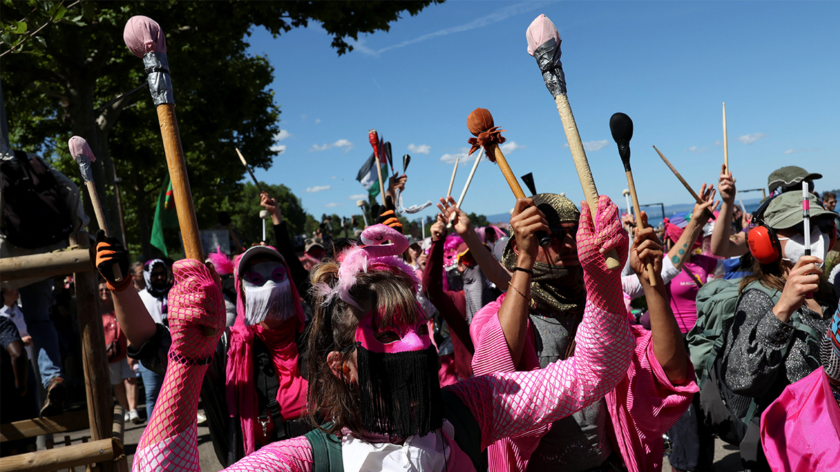 People hold a protest against the upcoming G7 summit