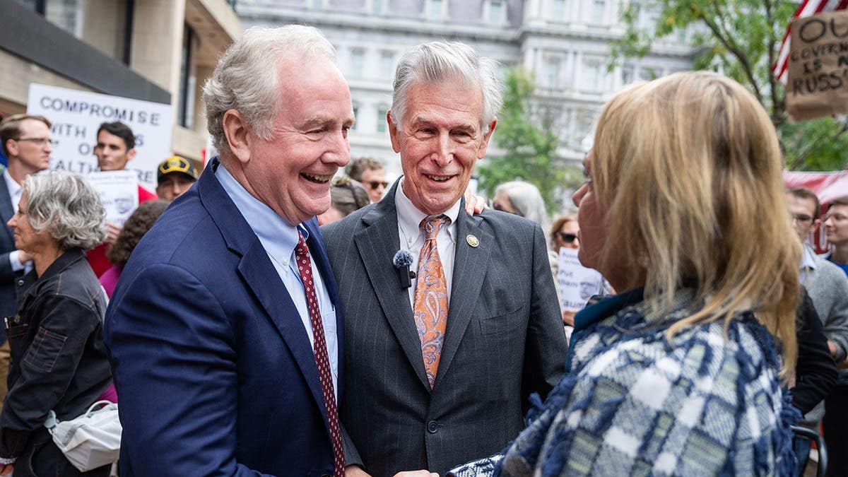 Sen. Chris Van Hollen and Reps. Don Beyer and April McClain Delaney speaking at a news conference outdoors.
