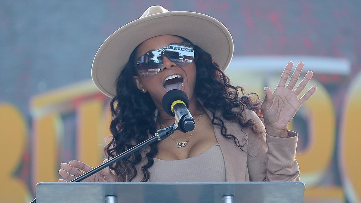 Tasha Steelz speaking during a live broadcast event in Arlington, Texas.