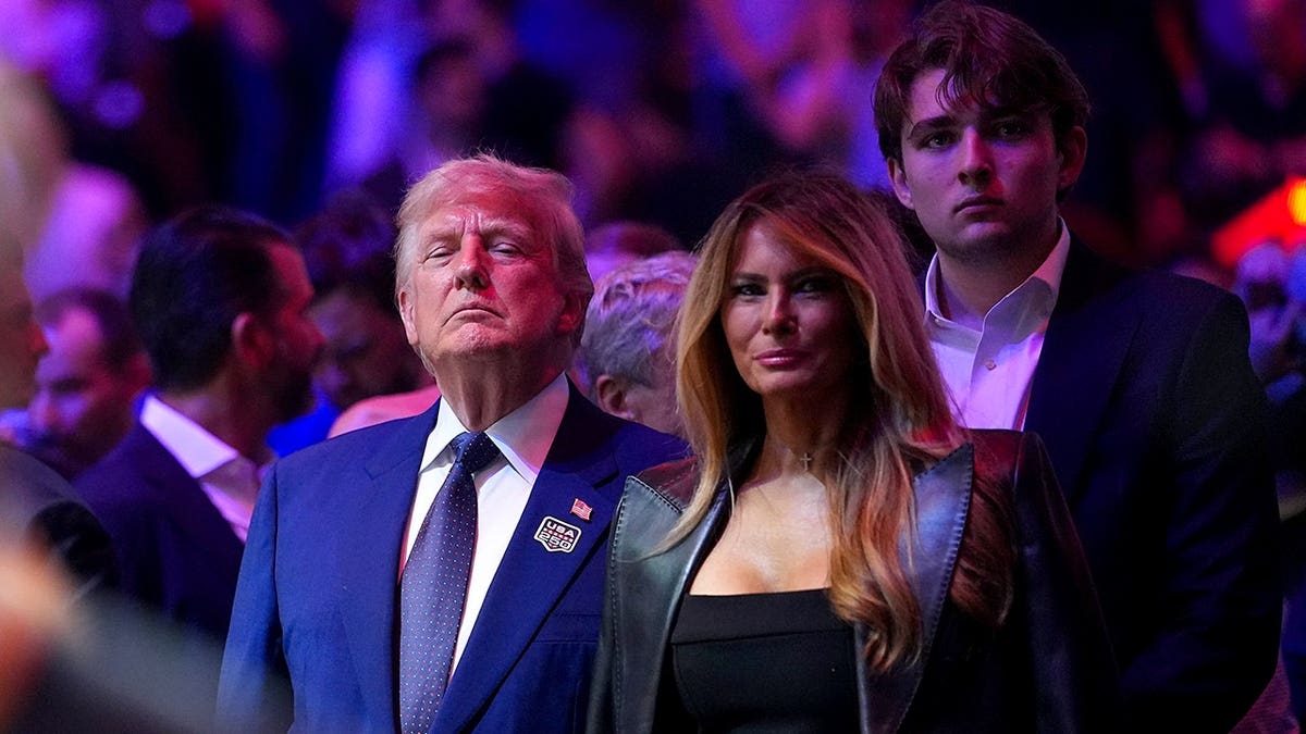 U.S. President Donald J. Trump, First Lady Melania Trump, and Barron Trump standing on the South Lawn at the White House