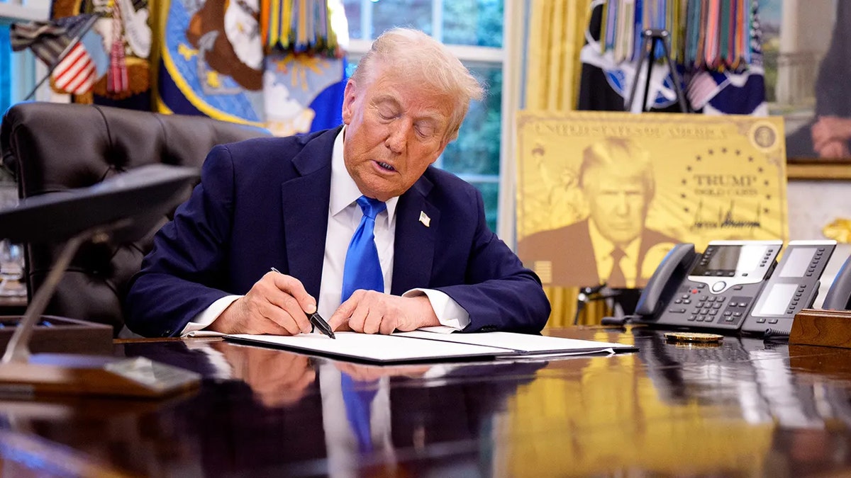 President Donald Trump signing executive orders in the Oval Office at the White House