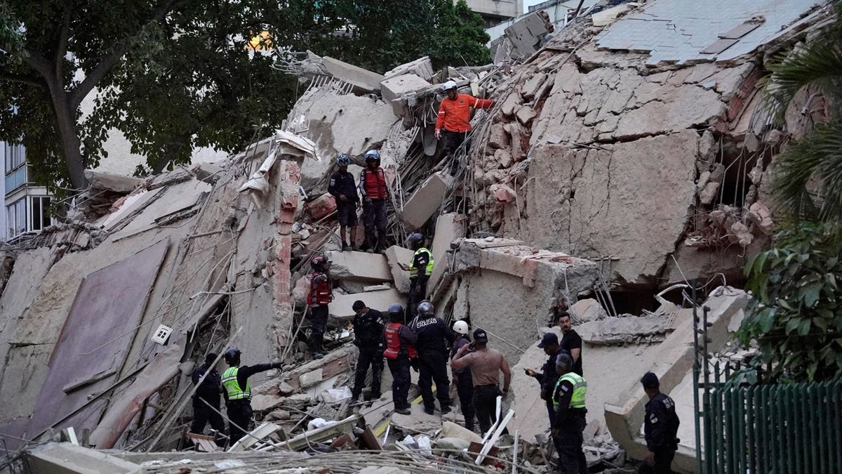 Rescuers search for victims in a collapsed building