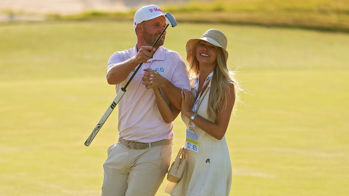 Wyndham Clark celebrating with girlfriend Emily Tanner at Shinnecock Hills Golf Club