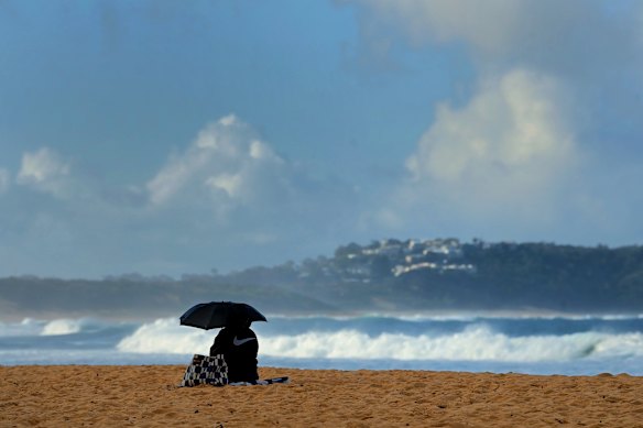 A woman sitting on Terrigal Beach.