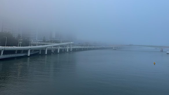 The fog blankets the city along the Brisbane River.