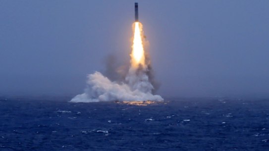 An image published by a Chinese state media outlet shows a missile being launched from a submarine in the South Pacific.