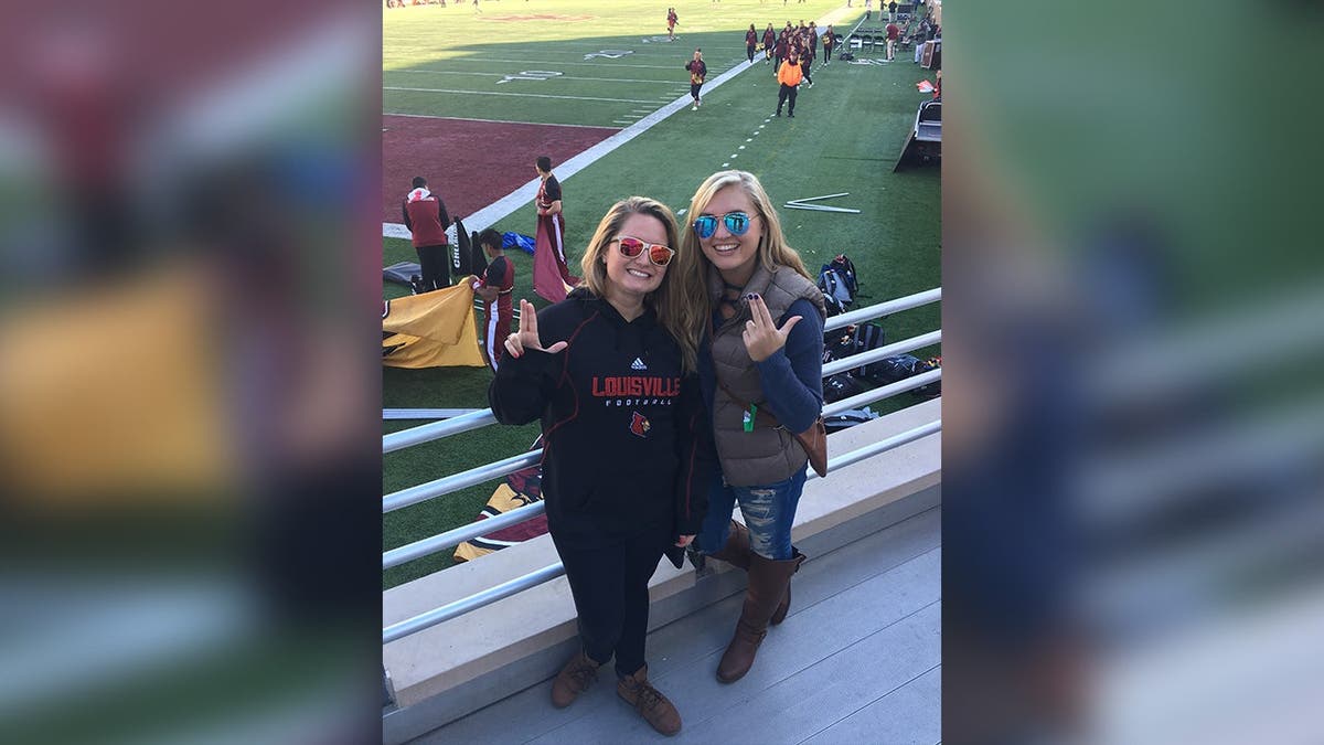 Jennifer and Brooke seen standing near bleachers to an athletic event