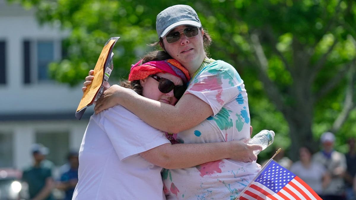 A Maine city counselor hugs a constituent following a shooting