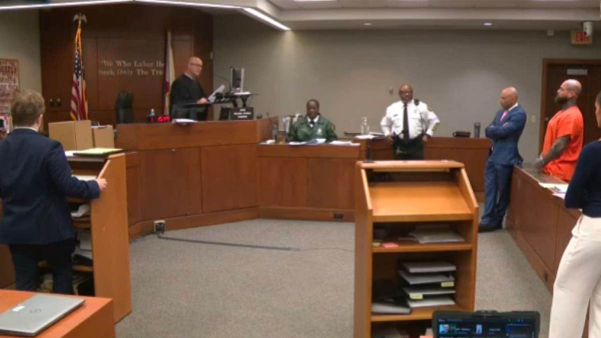 Wesley Watson stands in a Miami-Dade County courtroom during his guilty plea hearing