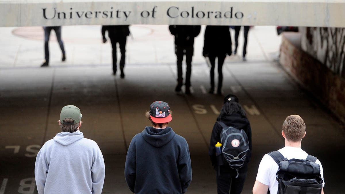 CU students walk under the University Hill bridge between classes.