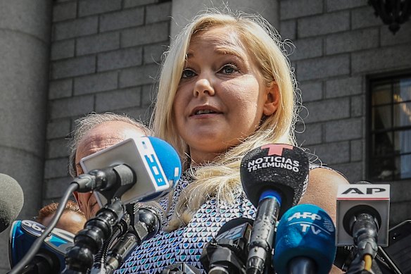 Virginia Giuffre is pictured here outside a Manhattan court after Jeffrey Epstein’s death in 2019. She received the equivalent of $US25 million in confidential payments after multiple legal battles over the years.
