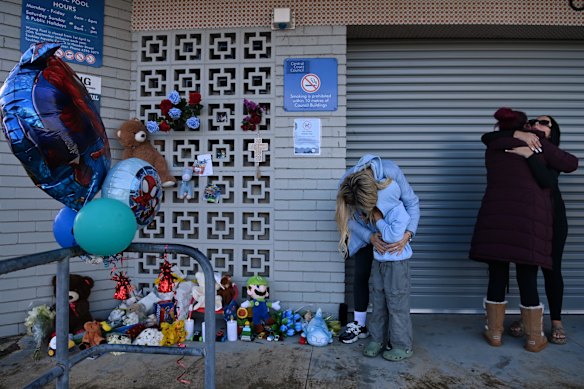 Families at a vigil for the dead boy.