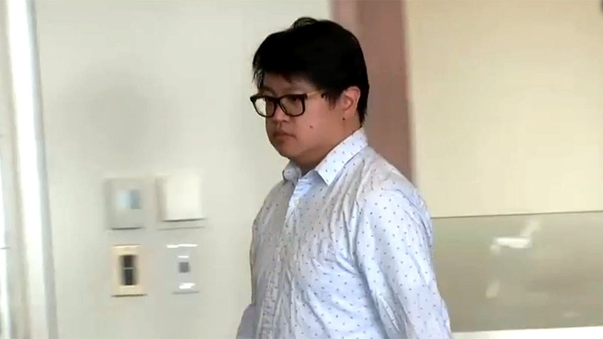Former Massachusetts teacher Tymond Tran walks inside Essex County Superior Court before his arraignment on child sex crime charges.