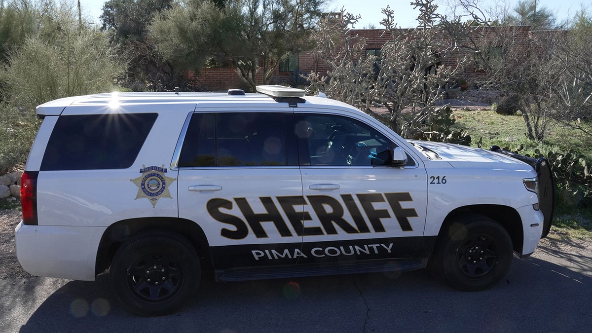 A Pima County Sheriff’s vehicle parked on the street in front of Nancy Guthrie’s house.