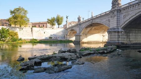 Ancient Roman bridge in the Tiber river exposed due to drought
