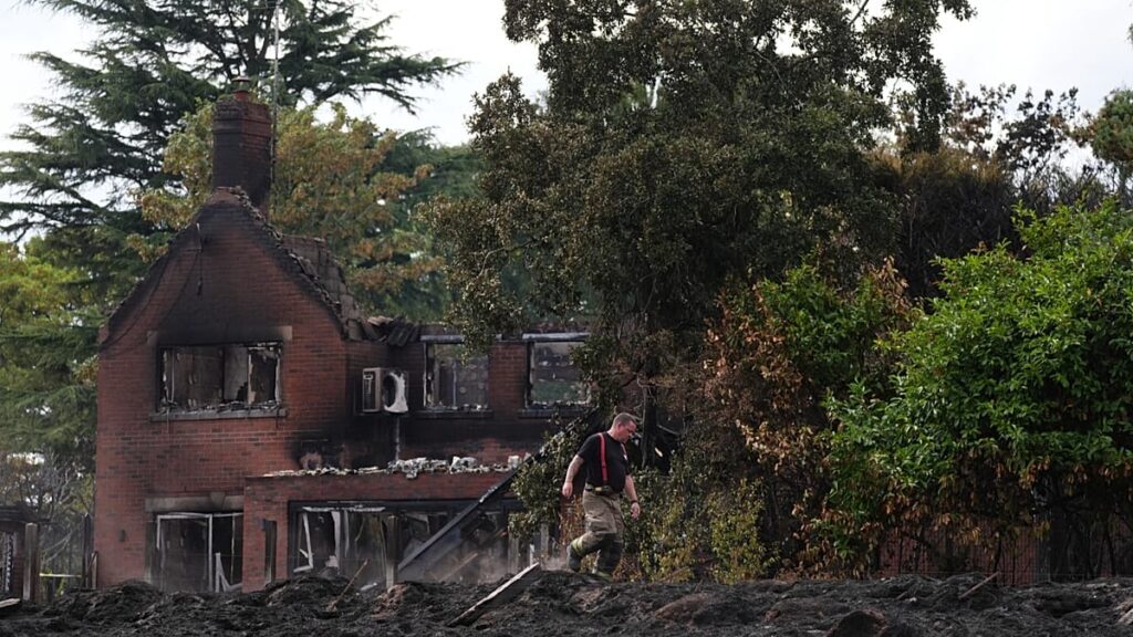 UK must 'face up to changing climate' as visits fire-hit town, PM says