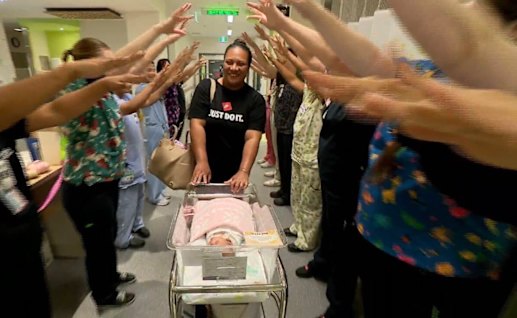 Staff congratulate mum Annrose and baby Miracle as she leaves hospital.