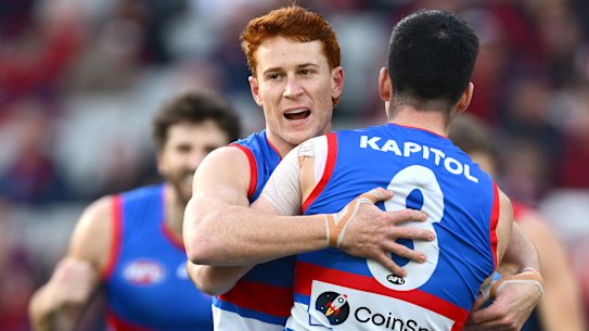 Matthew Kennedy of the Bulldogs is congratulated by Ed Richards.
