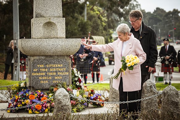 Never forgotten: Lynne Moore, with her son Craig Moore, lays roses in memory of her husband, Ray Moore, at Croydon war memorial on Sunday.