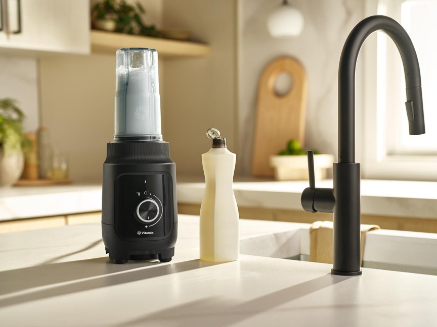 The black Vitamix Nano blender next to a sink and bottle of dish soap.