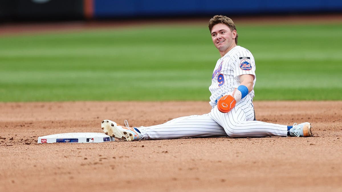 A.J. Ewing reacts after being tagged out at second base during a baseball game.